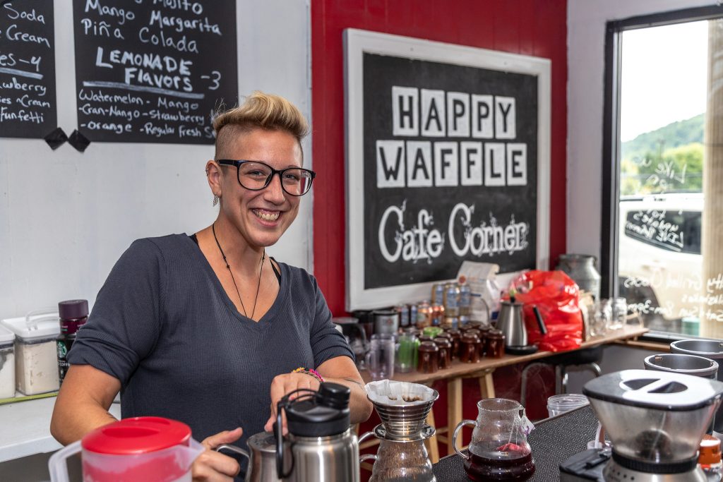 Photo by Dave Warner - Maria Salamone, owner of the Happy Waffle on Main St, makes a cup of coffee.