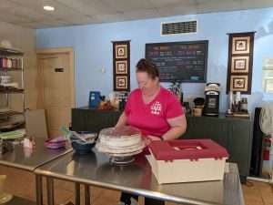Char Nichols prepares her space to decorate a cake.