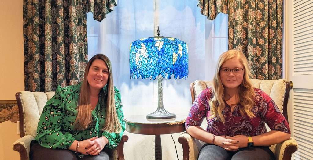 Noelle and Madison pose with a gorgeous Meyda Tiffany Lamp in the entryway.