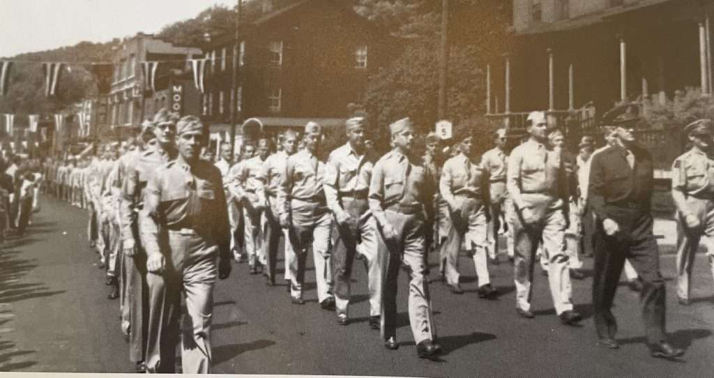 To the strains of “the Army goes Rolling Along”, Little Falls heroes marching down Main Street.