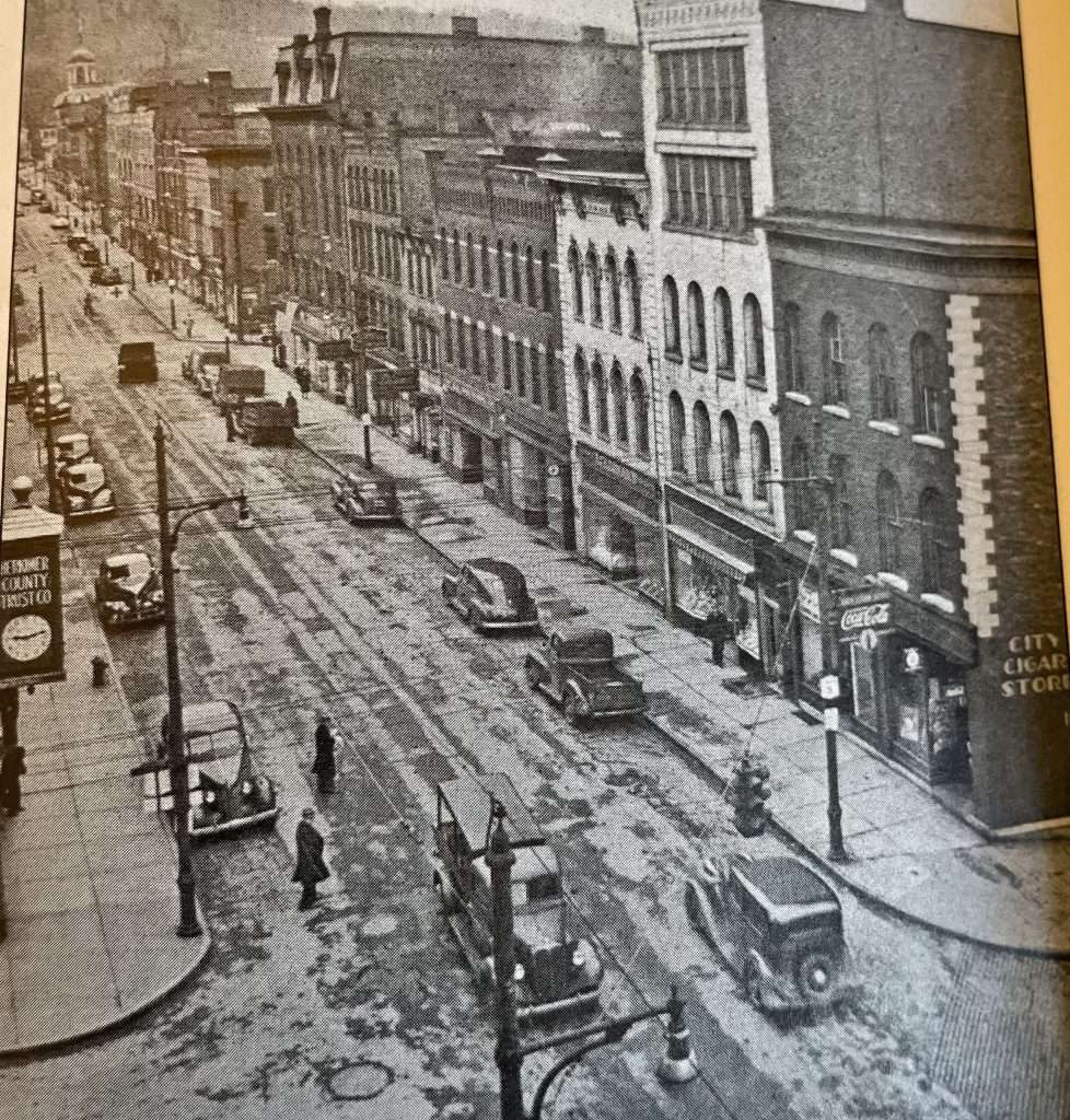 A good look at the south side of Main Street (photo from the 1930s) from the City Cigar Store on the corner of Main Street and Ann Street, to City Hall, seen in the distance, on the corner of Main Street and William Street.