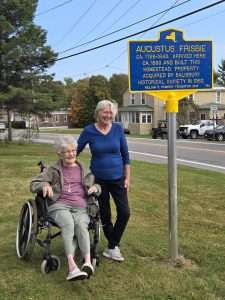 Nora Cool-Guinup stands to the right of Elaine Carlin after the unveiling of the historical marker.