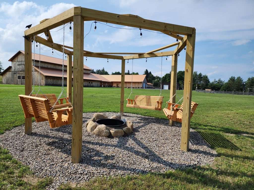 Rustic Ties “Sweetheart Swings” and fire pit feature. Photo used with permission from Rustic Ties