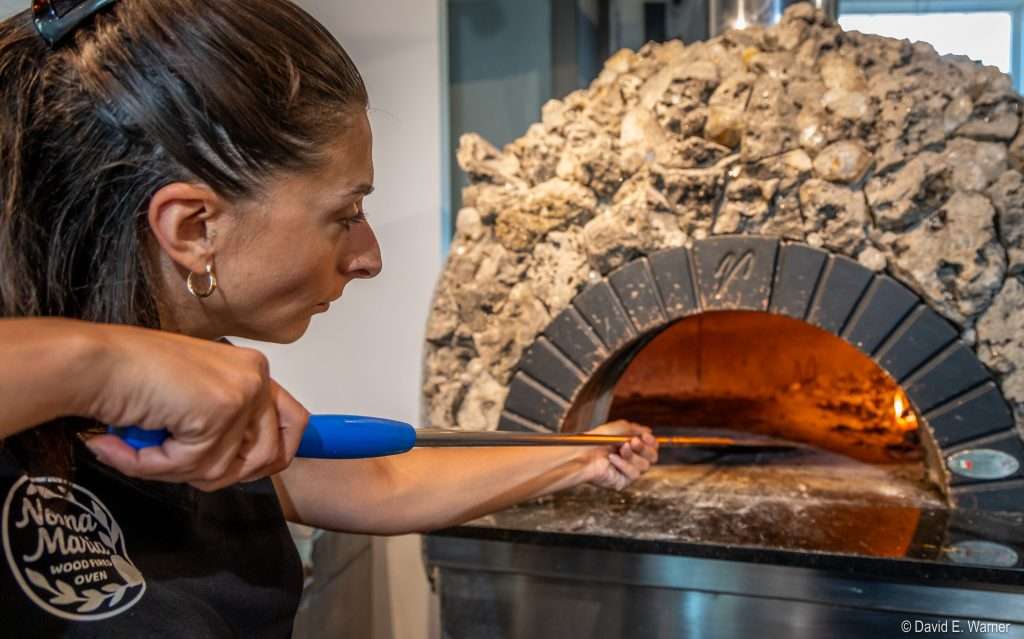 Marica Bellico puts a pizza into the oven at the new Nonna Maria's in Little Falls.